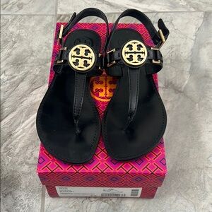 Tory Burch Cassia Flat Black and Gold Sandals with Iconic T-Strap Design